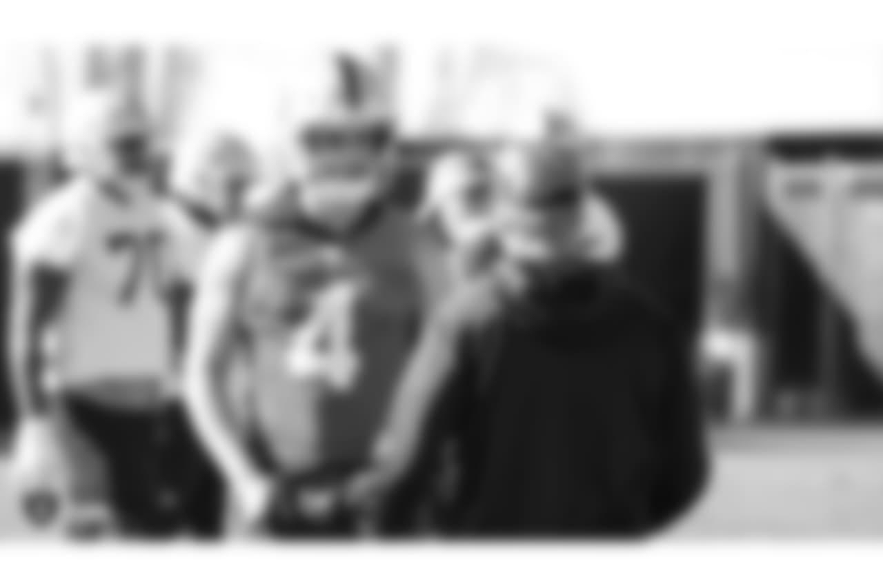 Oakland Raiders quarterback Derek Carr (4) and head coach Jon Gruden on the field for practice at the Oakland Raiders Practice Facility, Friday, December 28, 2018, in Alameda, California.