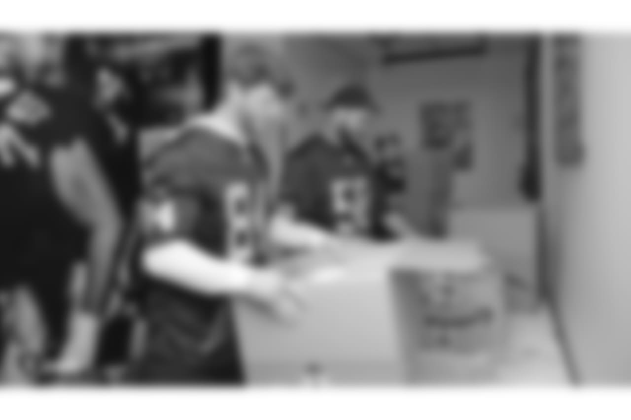 Oakland Raiders linebacker Kyle Wilber (58), tight end Paul Butler (84), tackle Jamar McGloster (64), defensive tackle Clinton McDonald (97), linebacker Shilique Calhoun (91), long snapper Andrew DePaola (48), the Raiderettes, and the Raiders Front Office in Alameda build care packages for victims of the Norther California Fires, Tuesday, November 20, 2018, in Alameda, California.