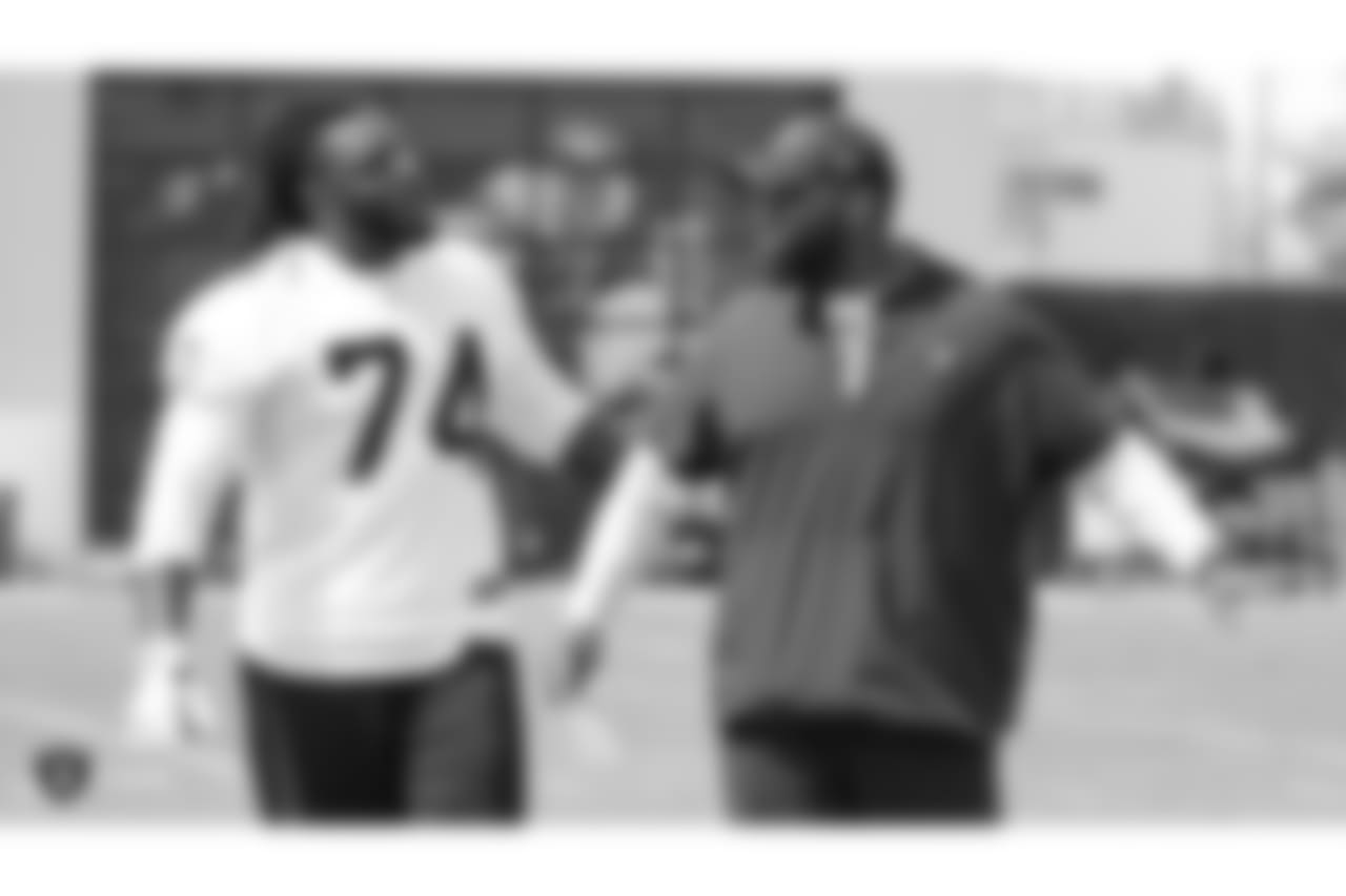 Oakland Raiders assistant offensive line coach Lemuel Jeanpierre talking to tackle TJ Clemmings (74) on the field for practice at the Oakland Raiders Practice Facility, Wednesday, September 12, 2018, in Alameda, California.