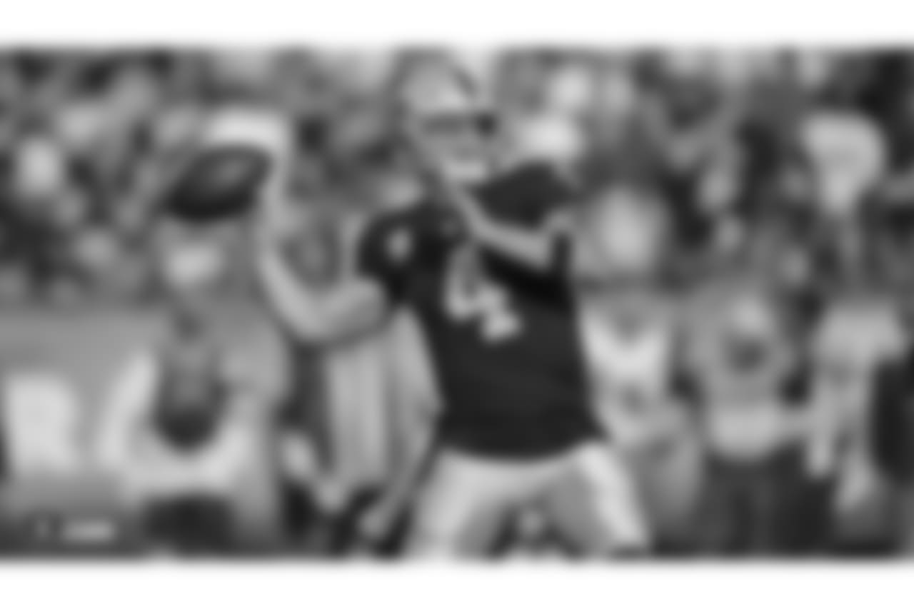 Oakland Raiders quarterback Derek Carr (4) makes a play during the Oakland Raiders regular season game against the Los Angeles Chargers at Oakland Alameda-County Coliseum on Sunday, November 11th, 2018, in Oakland, California. The Oakland Raiders lost 20-6.