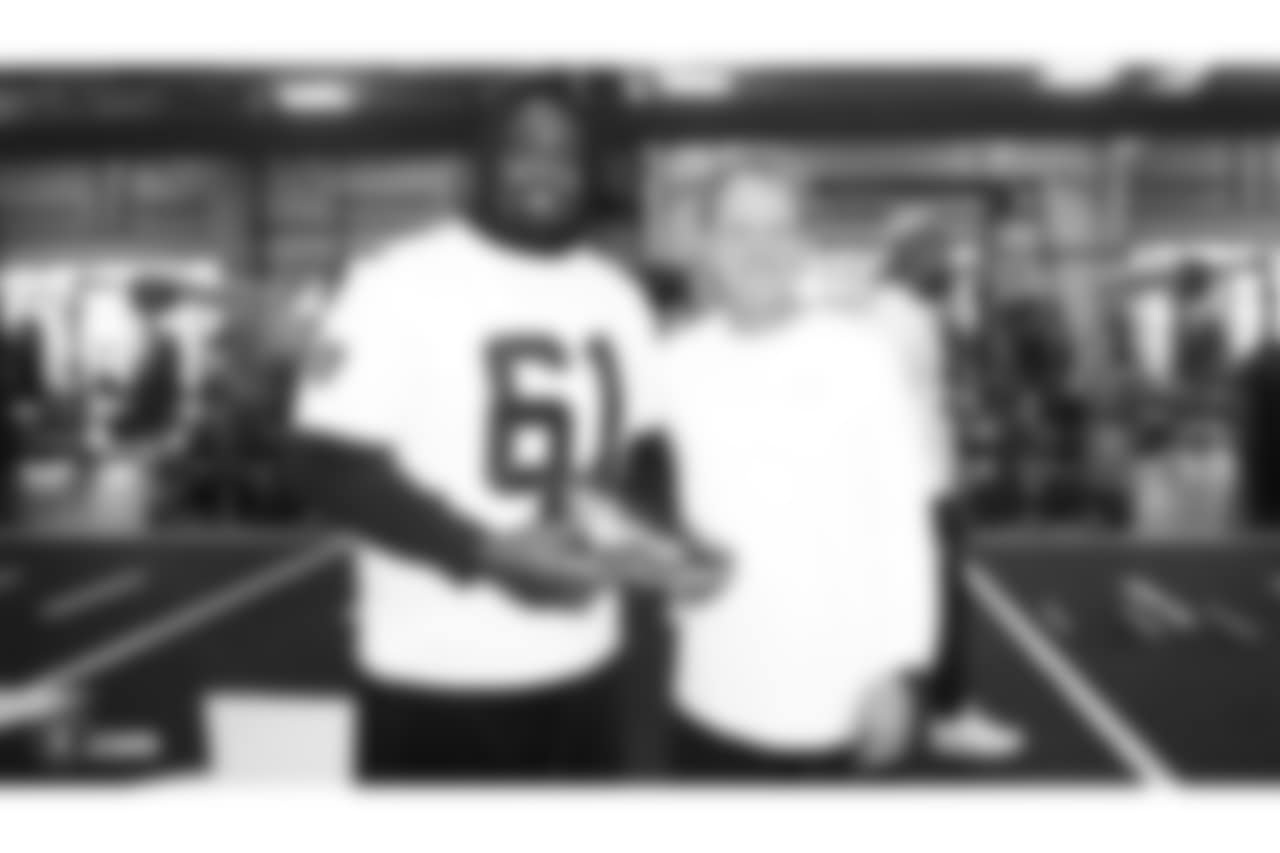 Oakland Raiders center Rodney Hudson (61) unboxes their custom cleats with equipment manager and painter of the cleats, Bobby Romanski, for the NFL's My Cause My Cleats campaign at the Oakland Raiders Practice Facility, Wednesday, November 21, 2018, in Alameda, California.