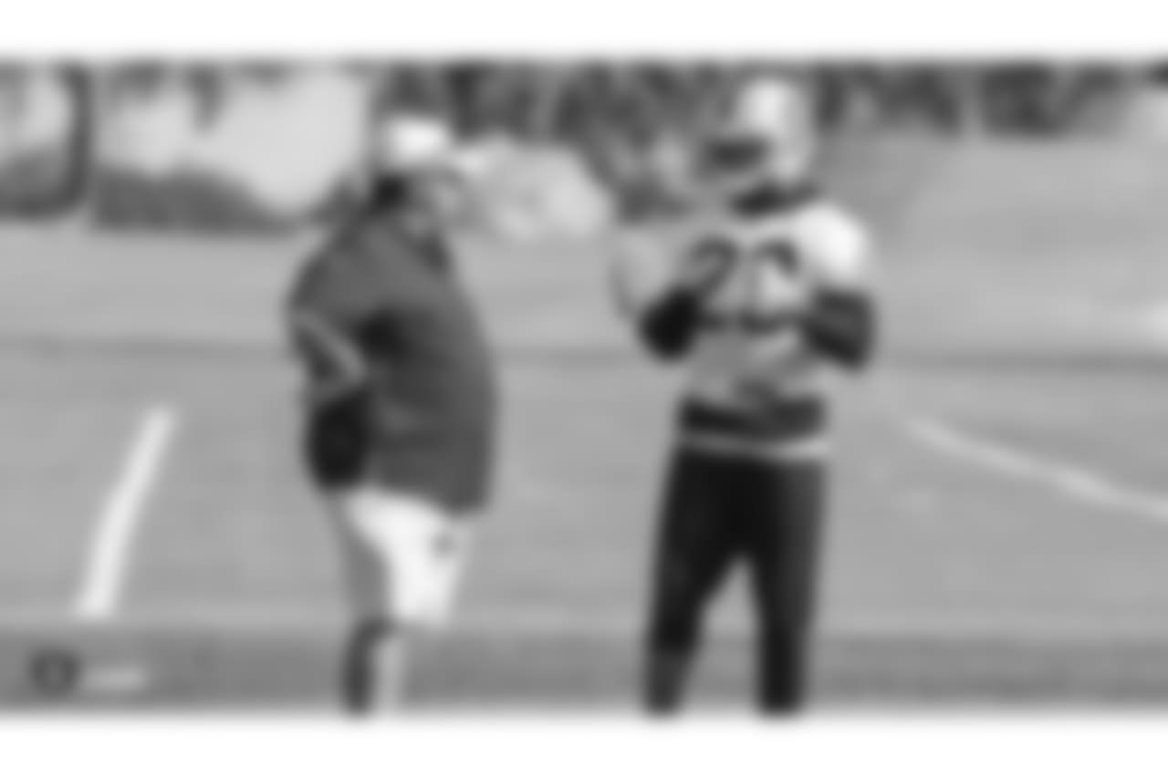 Oakland Raiders defensive coordinator Paul Guenther and cornerback Leon Hall (29) on the field for practice at the Oakland Raiders Practice Facility, Friday, October 26, 2018, in Alameda, California.