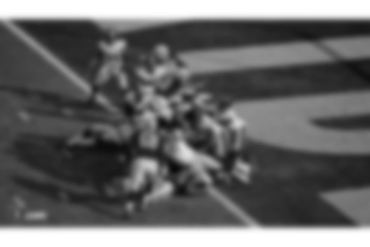 Oakland Raiders running back Doug Martin (28) leaps over the defense to score a touchdown during the Oakland Raiders regular season game against the Pittsburgh Steelers at Oakland Alameda-County Coliseum on Sunday, December 9th, 2018, in Oakland, California. The Oakland Raiders won 24-21.