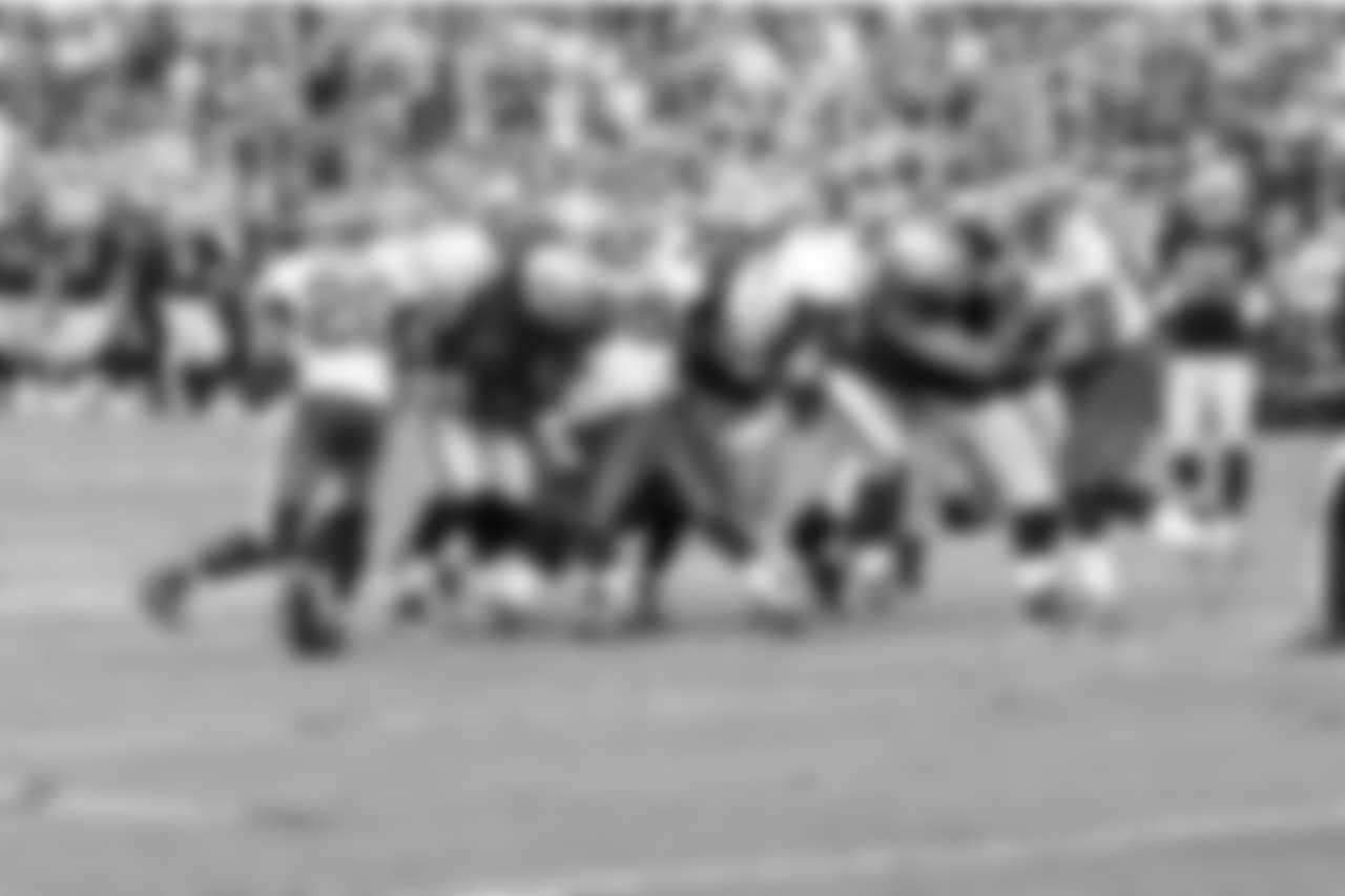 The offensive line pushes forward to give QB Carson Palmer room for the first down.