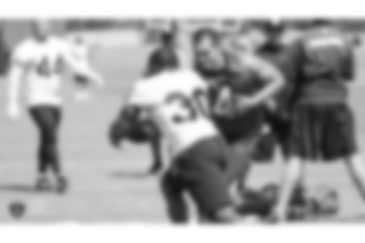 Oakland Raiders quarterback Derek Carr (4) handing off to running back Jalen Richard (30) on the field for practice at the Oakland Raiders Practice Facility, Wednesday, September 12, 2018, in Alameda, California.
