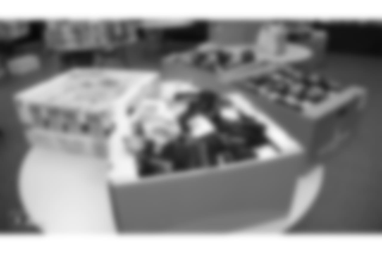 Oakland Raiders linebacker Kyle Wilber (58), tight end Paul Butler (84), tackle Jamar McGloster (64), defensive tackle Clinton McDonald (97), linebacker Shilique Calhoun (91), long snapper Andrew DePaola (48), the Raiderettes, and the Raiders Front Office in Alameda build care packages for victims of the Norther California Fires, Tuesday, November 20, 2018, in Alameda, California.