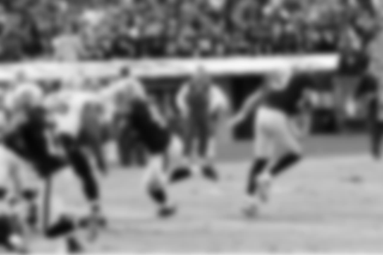 QB Carson Palmer hands the ball off to RB Marcel Reece.
