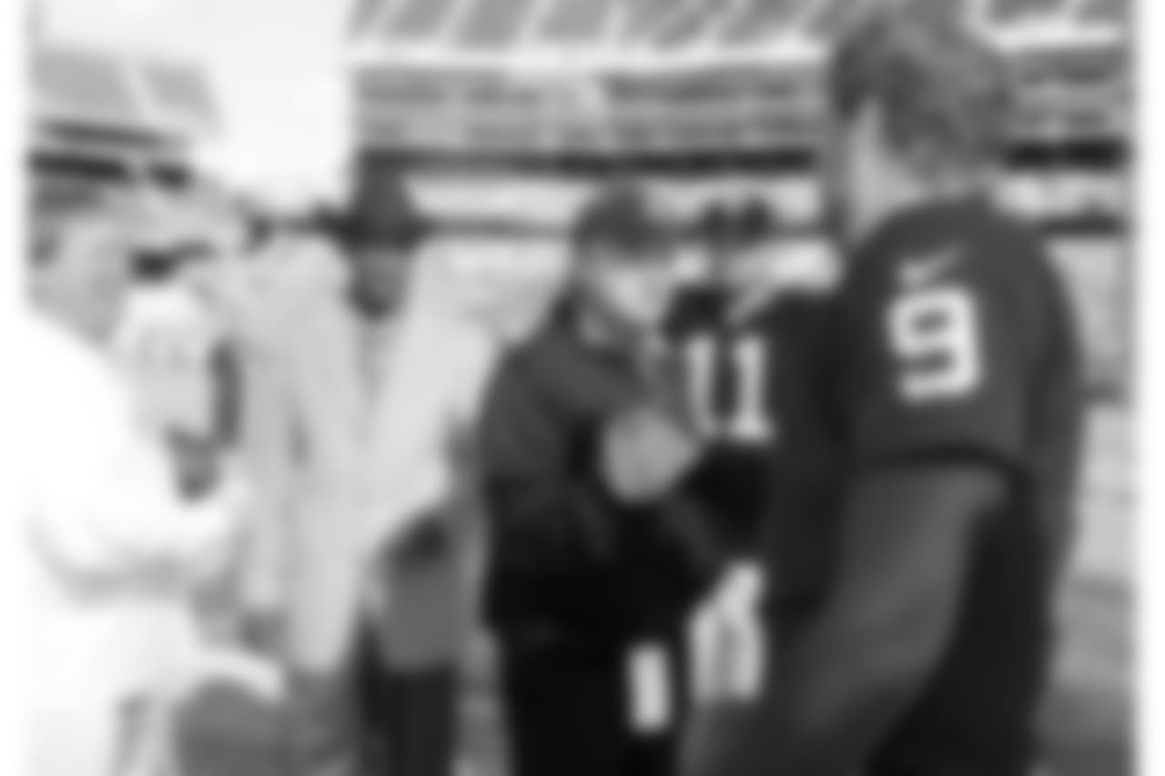 Former Raiders head coach Jon Gruden greets P Shane Lechler.