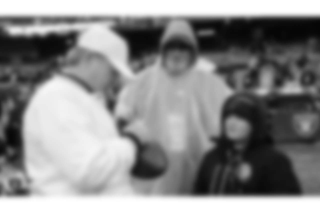 Zander of the Make-A-Wish Foundation stands with his family on the sidelines before the Oakland Raiders regular season game against the Denver Broncos at Oakland-Alameda County Coliseum, Monday, December 24, 2018, in Oakland, California. The Oakland Raiders won 24-17.