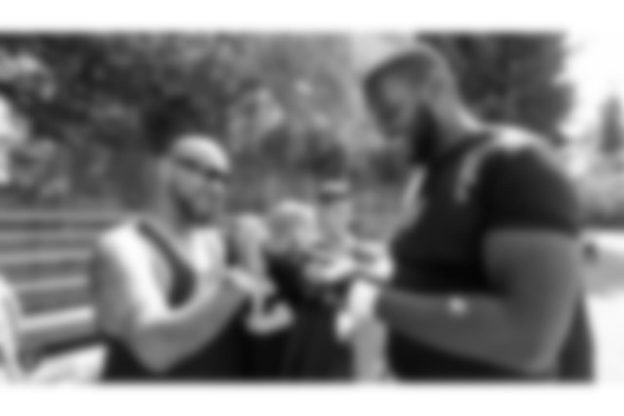 Oakland Raiders offensive tackle Brandon Parker (75) signs autographs for fans after practice at 2018 Training Camp at The Oakland Raiders Napa Valley Training Complex, Tuesday, August 14, 2018, in Napa, California.
