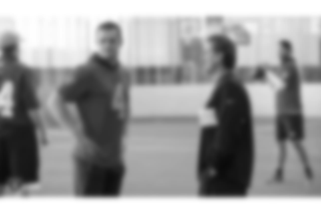 Oakland Raiders quarterback Derek Carr (4) and offensive coordinator Greg Olson on the field for a walk through at Bladium Sports & Fitness, Thursday, November 15, 2018, in Alameda, California.