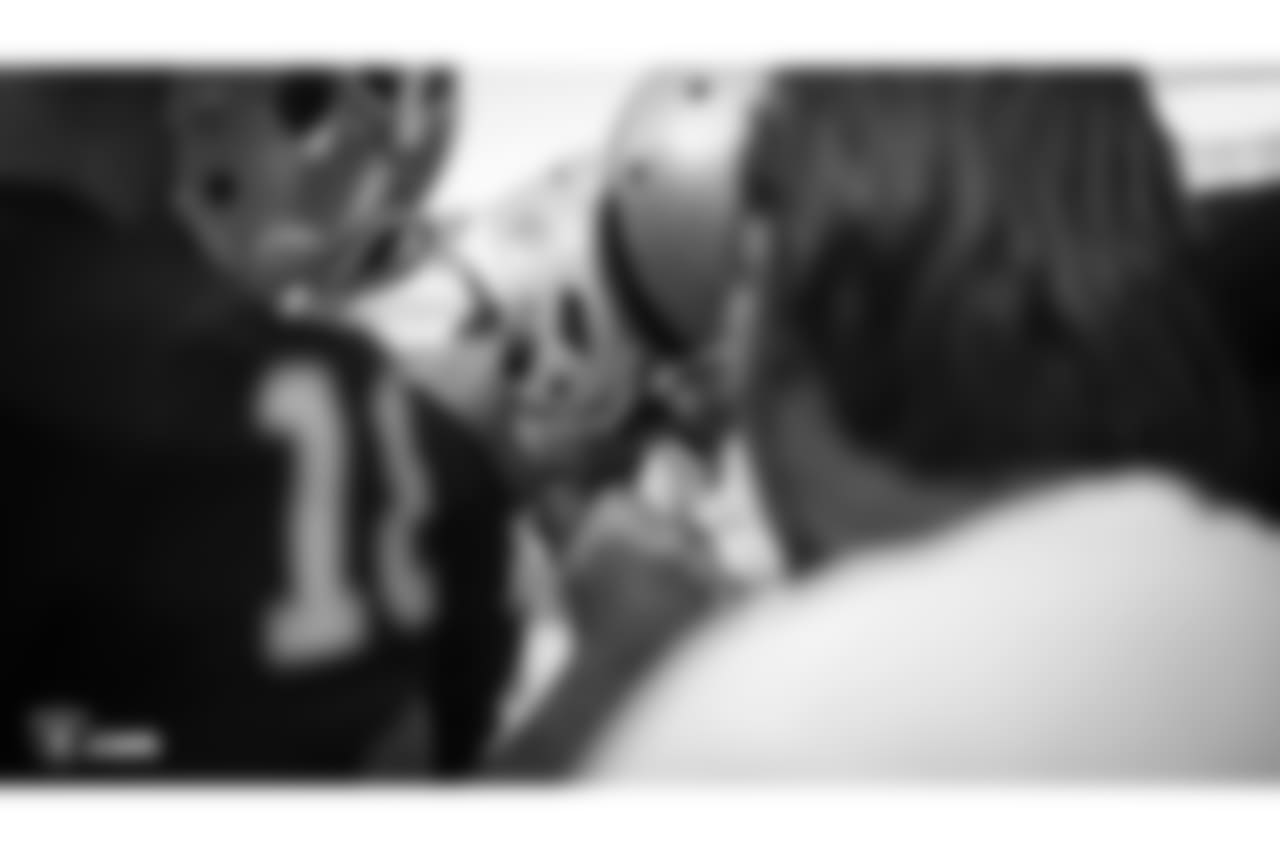 Oakland Raiders quarterback Derek Carr (4), quarterback EJ Manuel (3), and quarterback Connor Cook (18) huddle up before their preseason game against the Green Bay Packers at Oakland-Alameda County Coliseum, Friday, August 24, 2018, in Oakland, California. The Oakland Raiders won 13-6.