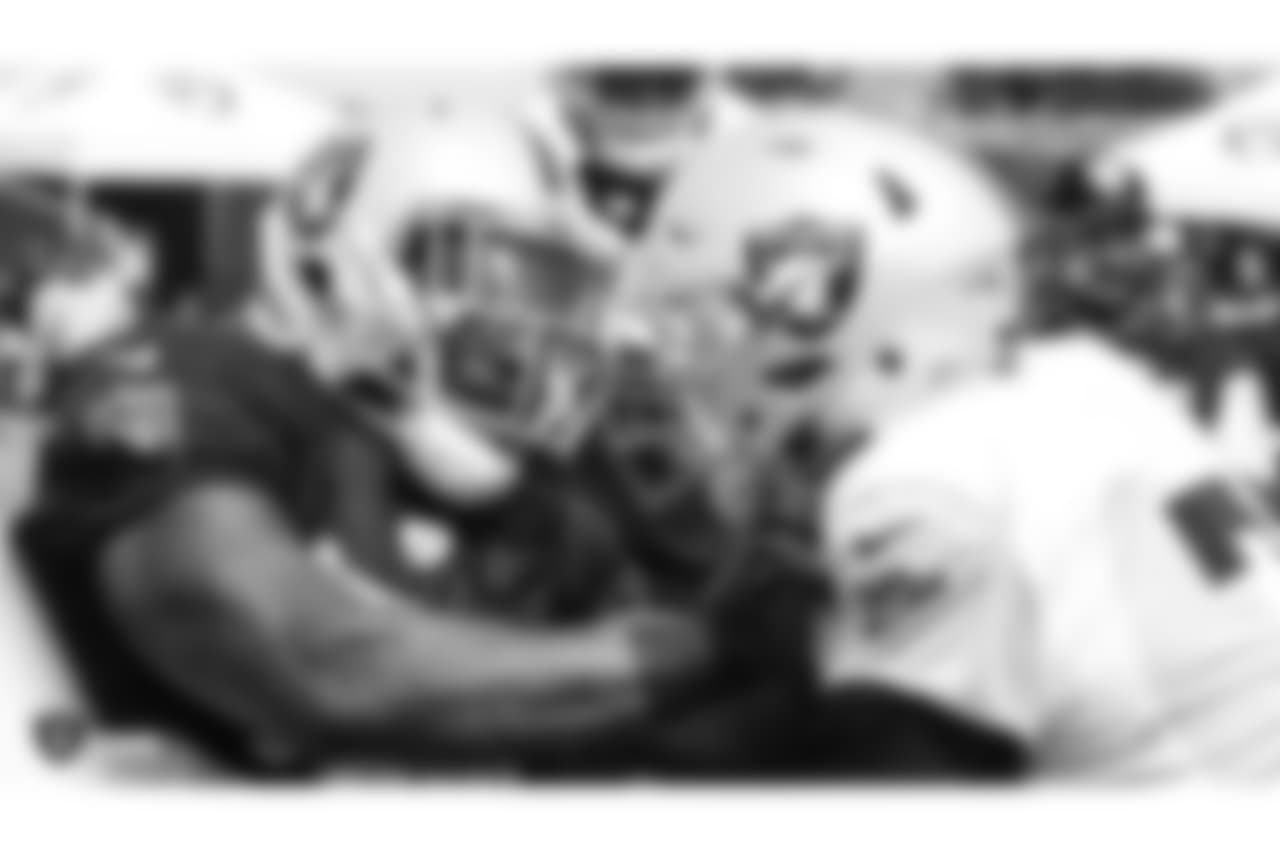 Oakland Raiders outside linebacker Bruce Irvin (51) and offensive tackle Kolton Miller (77) on the field for practice at 2018 Training Camp at The Oakland Raiders Napa Valley Training Complex, Friday, August 3, 2018, in Napa, California.