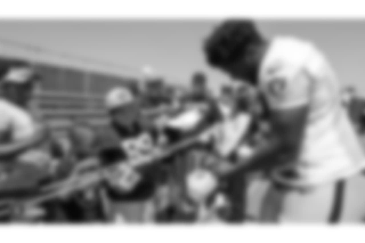 Oakland Raiders offensive tackle Jylan Ware (69) signs autographs for fans after practice at 2018 Training Camp at The Oakland Raiders Napa Valley Training Complex, Monday, August 6, 2018, in Napa, California.