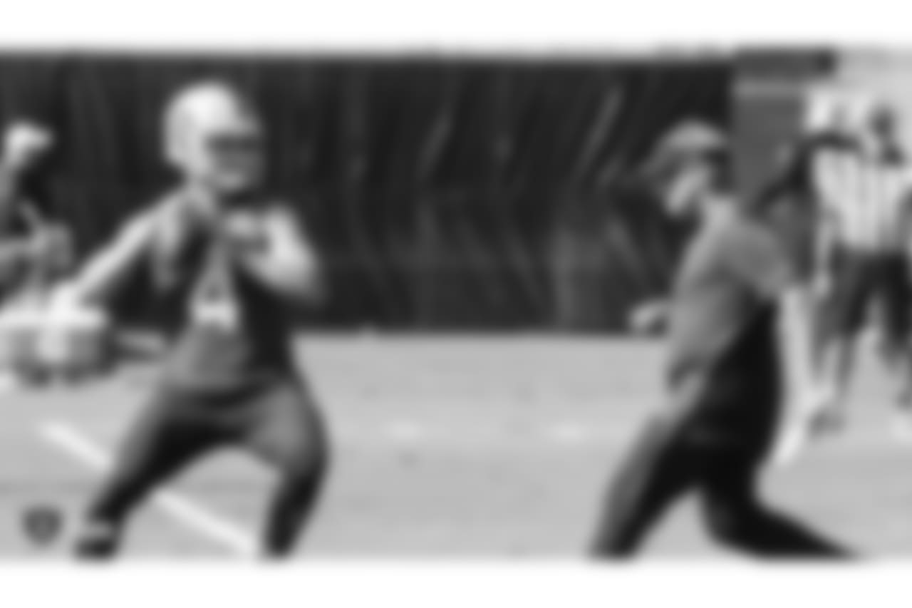 Oakland Raiders quarterback Derek Carr (4) and head coach Jon Gruden on the field for practice at the Oakland Raiders Practice Facility, Thursday, October 25, 2018, in Alameda, California.