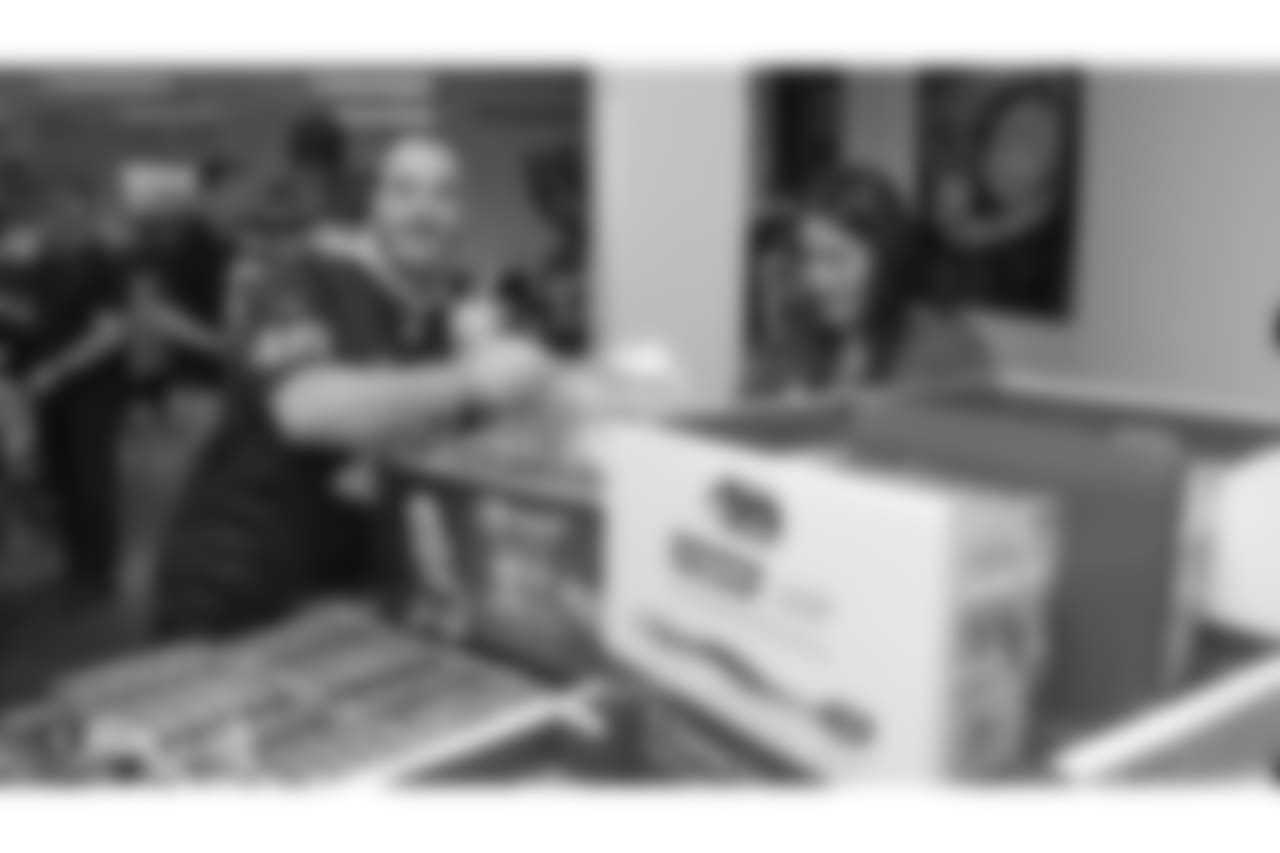 Oakland Raiders linebacker Kyle Wilber (58), tight end Paul Butler (84), tackle Jamar McGloster (64), defensive tackle Clinton McDonald (97), linebacker Shilique Calhoun (91), long snapper Andrew DePaola (48), the Raiderettes, and the Raiders Front Office in Alameda build care packages for victims of the Norther California Fires, Tuesday, November 20, 2018, in Alameda, California.