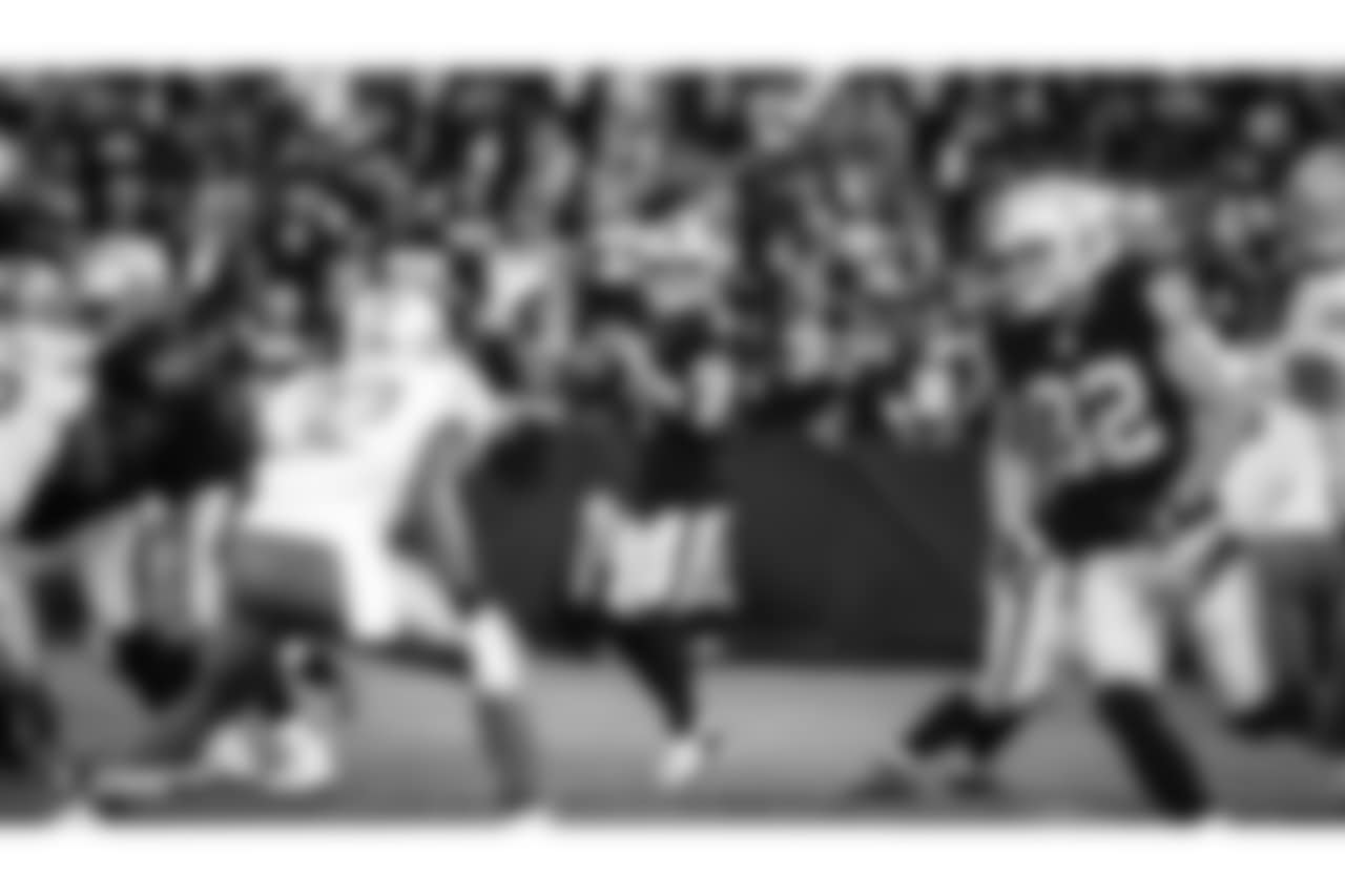 Oakland Raiders quarterback Derek Carr (4) looks upfield during the Oakland Raiders game against the Detroit Lions at Oakland-Alameda County Coliseum, Friday, August 10, 2018, in Oakland, California. The Oakland Raiders won 16-10.