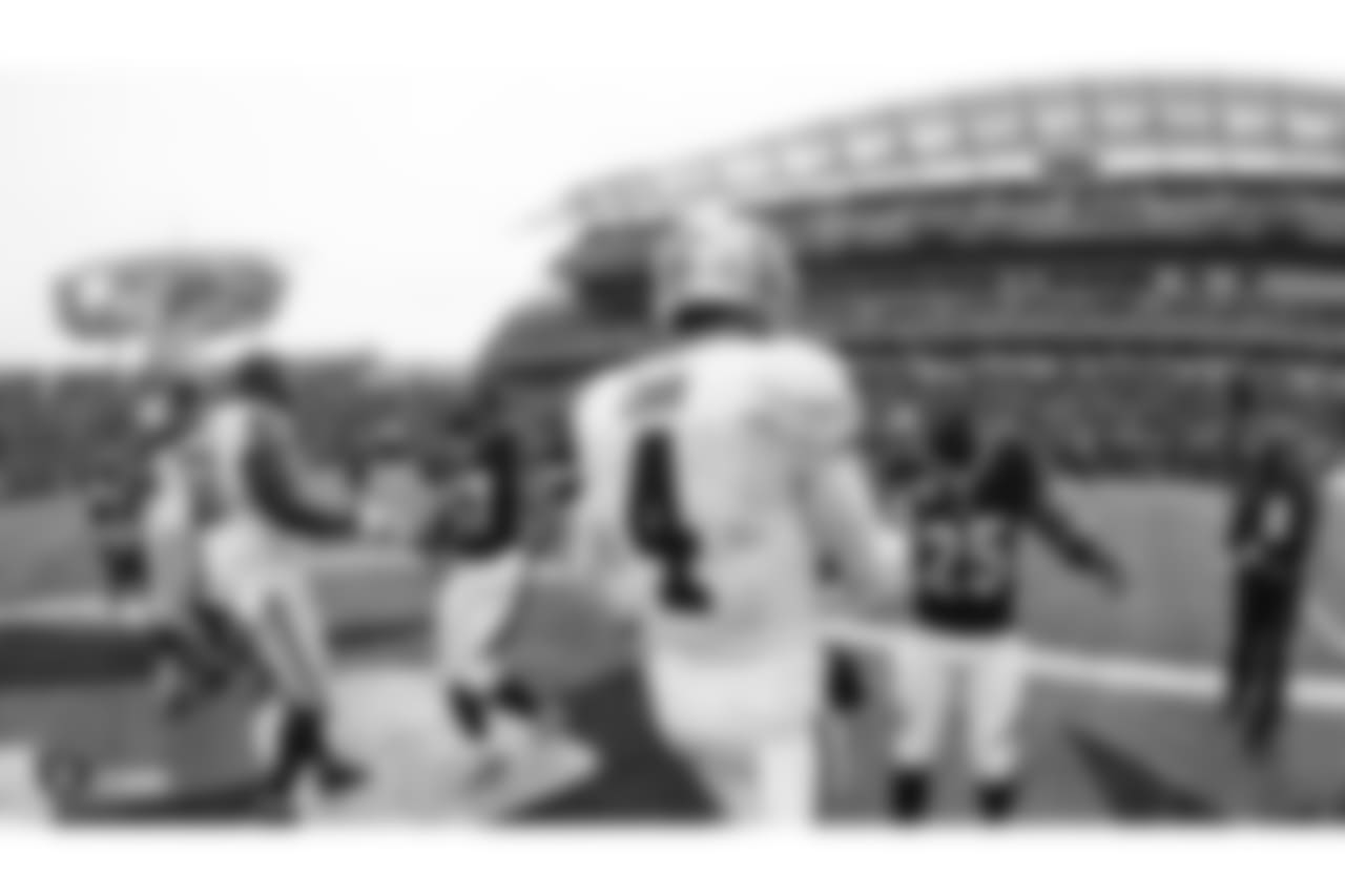Oakland Raiders defensive tackle Frostee Rucker (98), center Rodney Hudson (61), and quarterback Derek Carr (4) during the coin toss before the Oakland Raiders regular season game against the Cincinnati Bengals at Paul Brown Stadium, Sunday, December 16, 2018, in Cincinnati, Ohio. The Oakland Raiders lost 30-16.