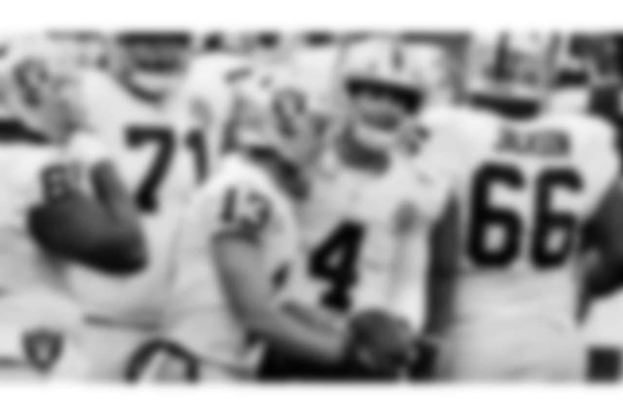 Las Vegas Raiders wide receiver Hunter Renfrow (13) and quarterback Derek Carr (4) celebrate after a 4-yard touchdown pass during the regular season away game against the Cleveland Browns .