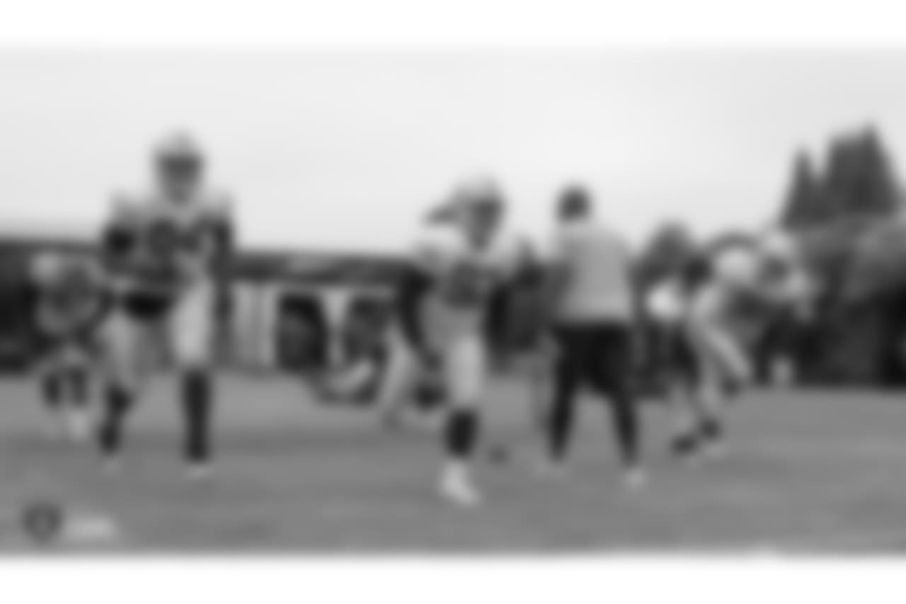 Oakland Raiders defensive lineman Shakir Soto (64), defensive tackle PJ Hall (92), assistant defensive line coach Marco Coleman, and defensive tackle Frostee Rucker (98) on the field for practice at 2018 Training Camp at The Oakland Raiders Napa Valley Training Complex, Monday, August 13, 2018, in Napa, California.