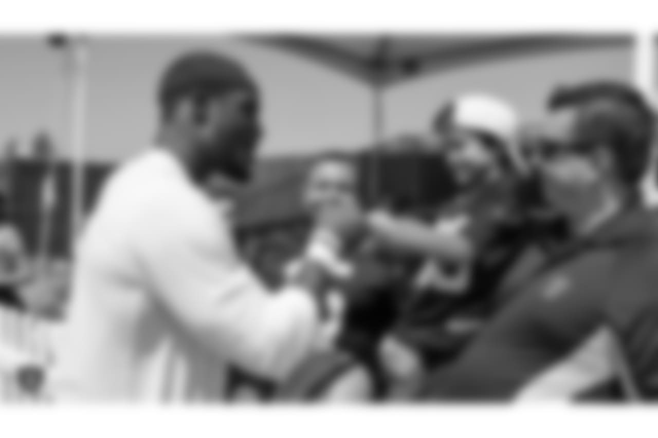 Oakland Raiders linebacker Tahir Whitehead (59) signs autographs for fans after practice at 2018 Training Camp at The Oakland Raiders Napa Valley Training Complex, Monday, August 13, 2018, in Napa, California.