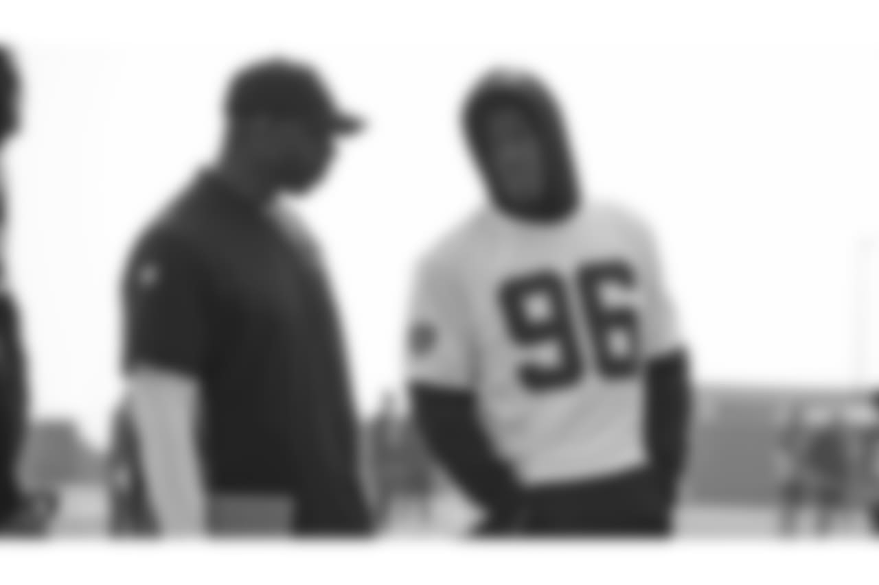 Oakland Raiders assistant defensive line coach Marco Coleman defensive end Kony Ealy (96) on the field for practice at the Oakland Raiders Practice Facility, Friday, November 9, 2018, in Alameda, California.