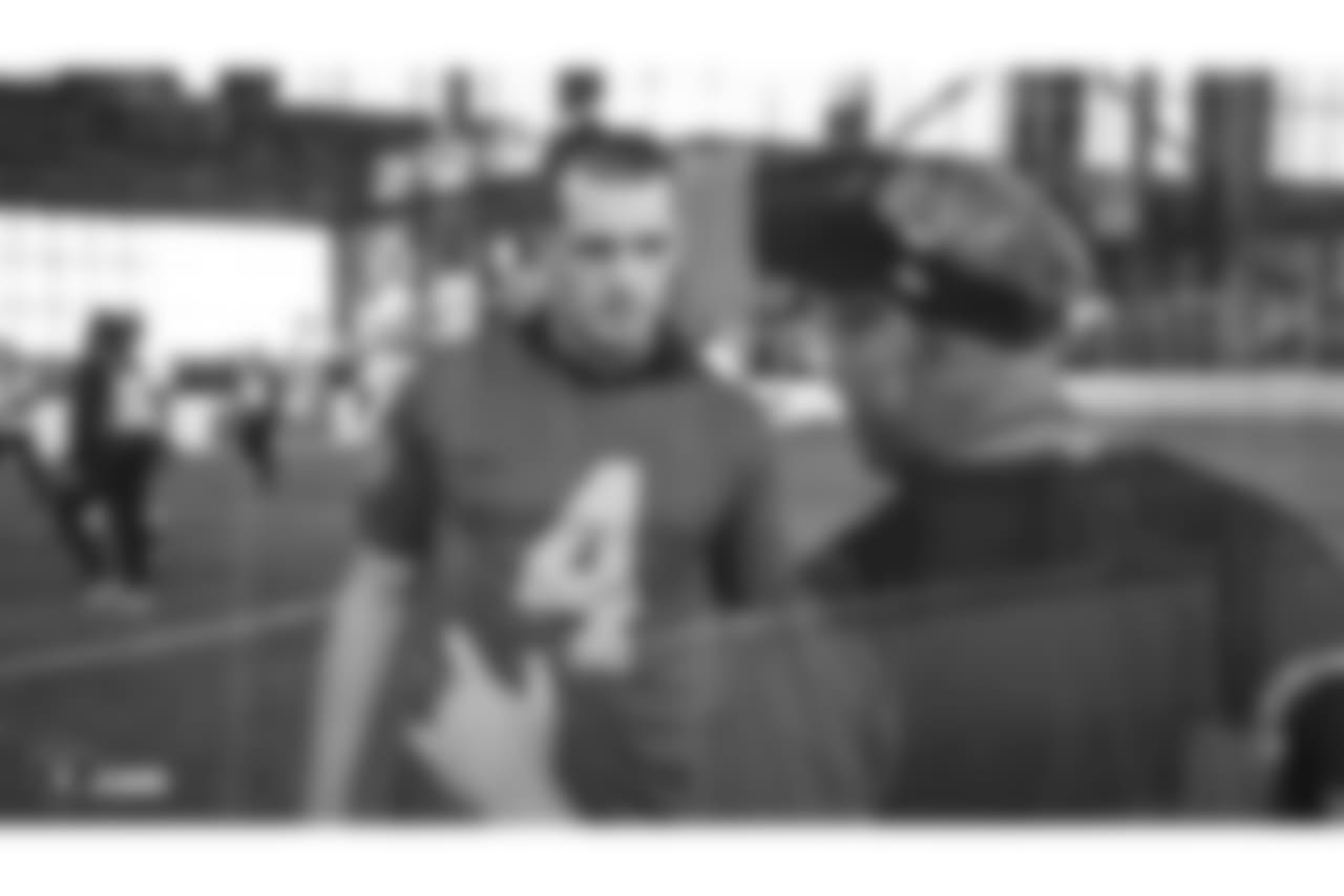 Oakland Raiders quarterback Derek Carr (4) and head coach Jon Gruden on the field for a walk through at Bladium Sports & Fitness, Thursday, November 15, 2018, in Alameda, California.