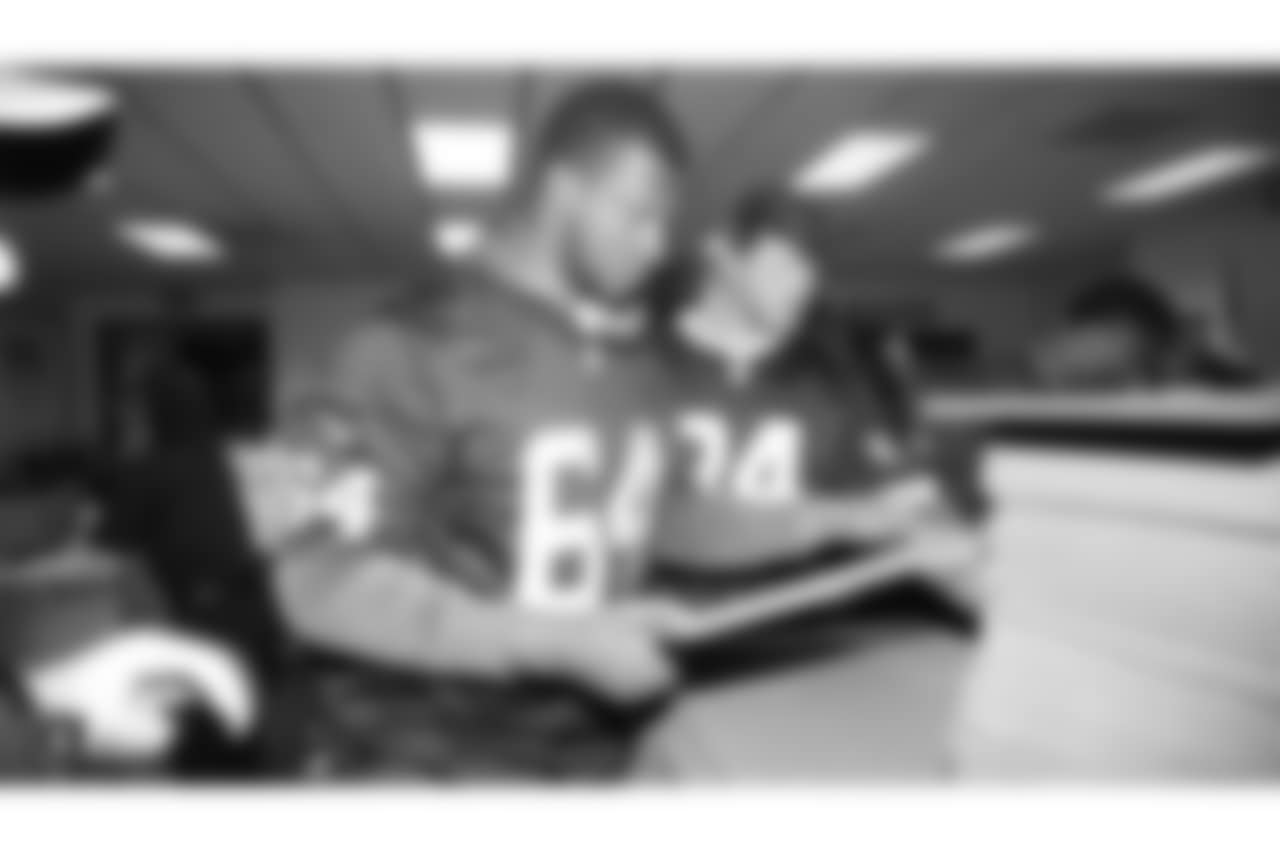 Oakland Raiders linebacker Kyle Wilber (58), tight end Paul Butler (84), tackle Jamar McGloster (64), defensive tackle Clinton McDonald (97), linebacker Shilique Calhoun (91), long snapper Andrew DePaola (48), the Raiderettes, and the Raiders Front Office in Alameda build care packages for victims of the Norther California Fires, Tuesday, November 20, 2018, in Alameda, California.