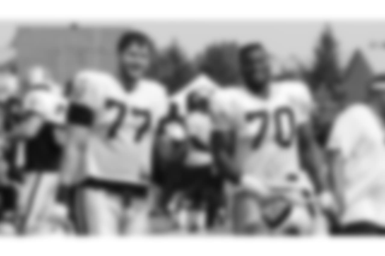 Oakland Raiders offensive tackle Kolton Miller (77) and offensive guard Kelechi Osemele (70) on the field for practice at 2018 Training Camp at The Oakland Raiders Napa Valley Training Complex, Friday, August 3, 2018, in Napa, California.