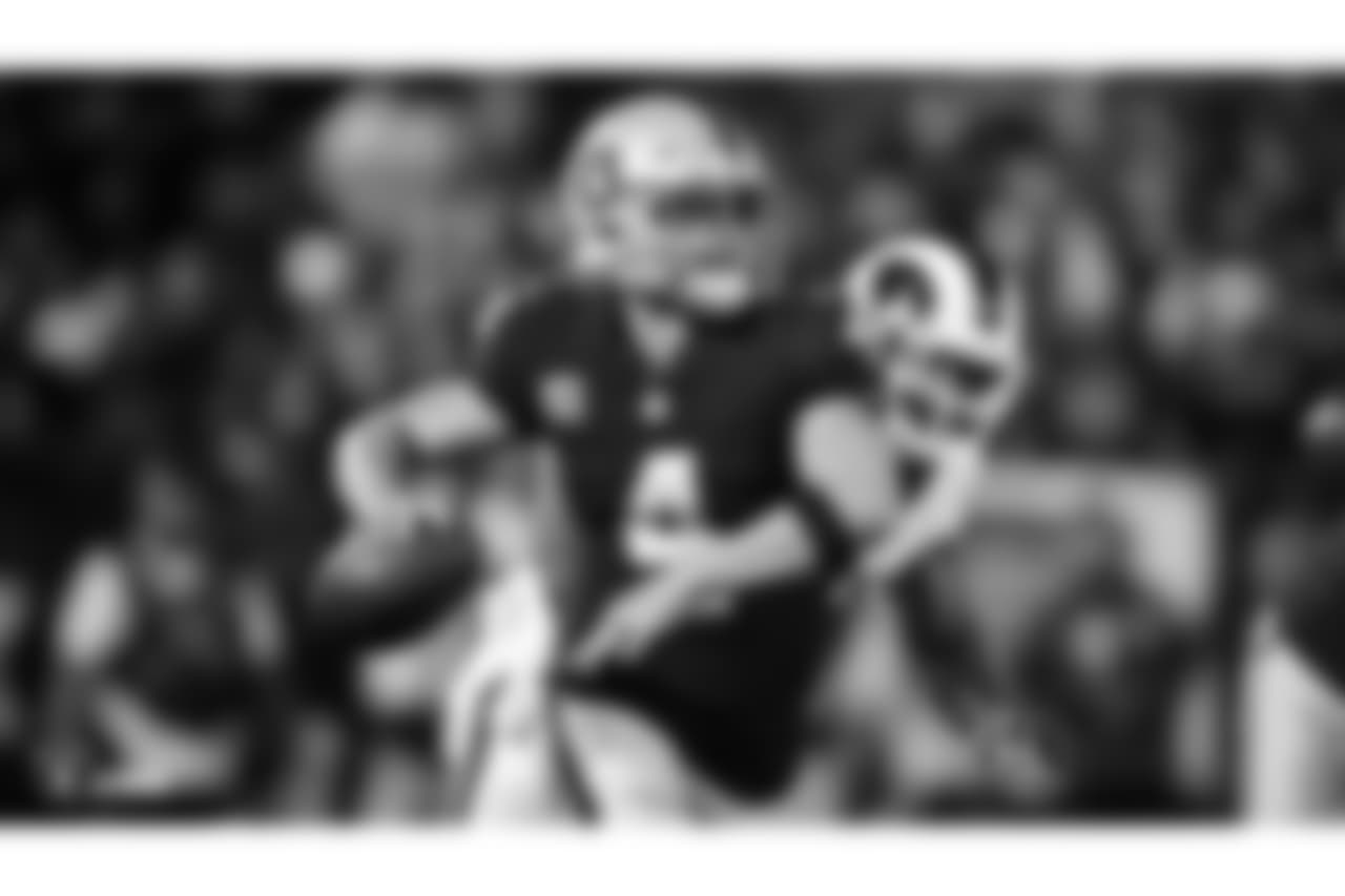 Oakland Raiders quarterback Derek Carr (4) makes a play during the Oakland Raiders regular season game against the Los Angeles Rams at Oakland-Alameda County Coliseum, Monday, September 10th in Oakland, California. The Oakland Raiders lost 33-13.