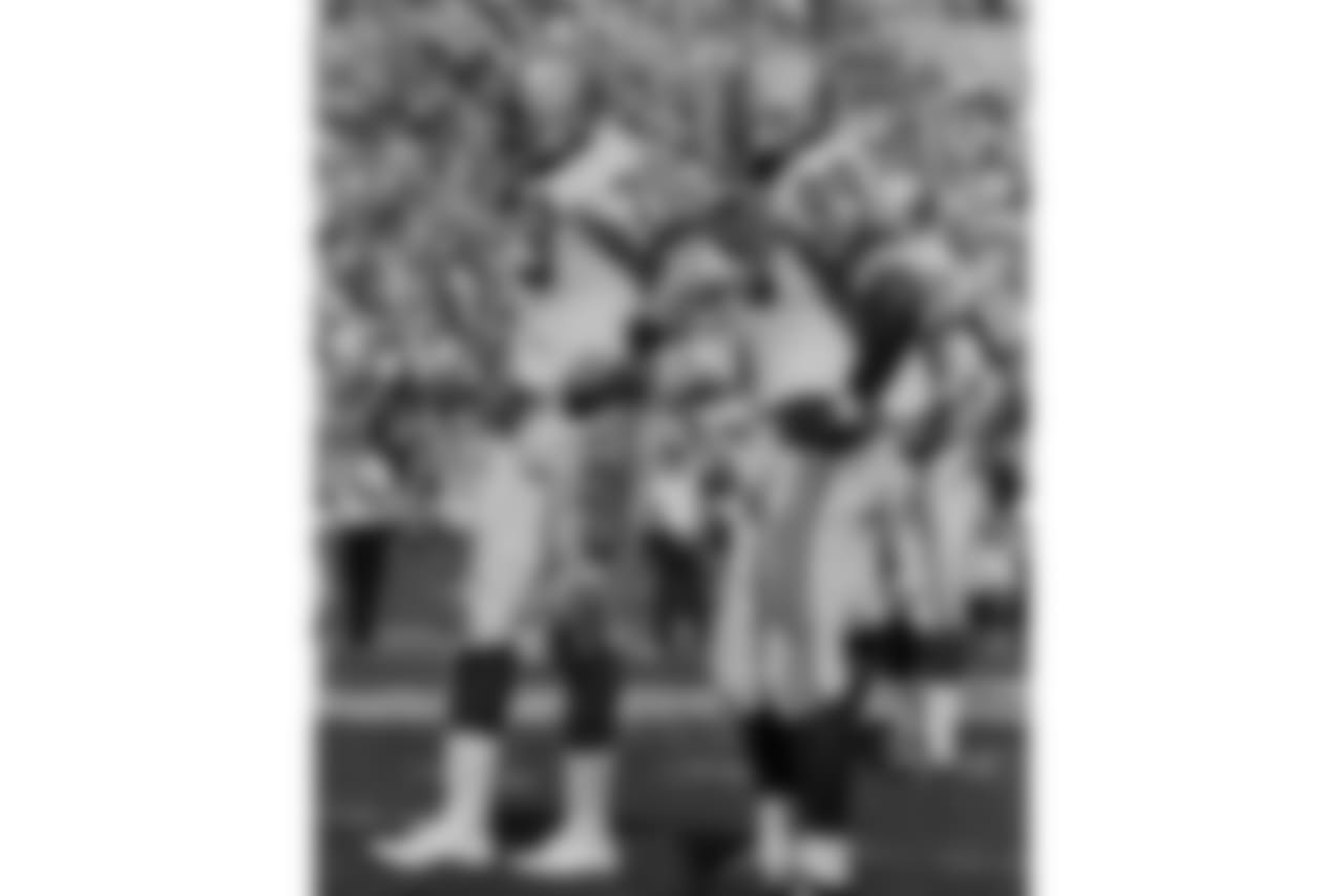 Deacon Jones (79) Dave Robinson (89) wait between plays during the 1968 NFL Pro Bowl in Los Angeles, Calif., Jan. 21, 1968. The West defeated the East 38-20. (AP Photo/NFL Photos)