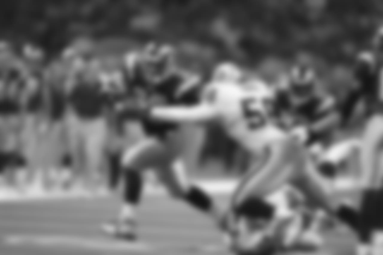 "St. Louis Rams Marshall Faulk runs for yardage against the Oakland Raiders during a game on October 13, 2002 in St. Louis. The Rams won, 28-13. (Photo by Bill Stover/St. Louis Rams)"