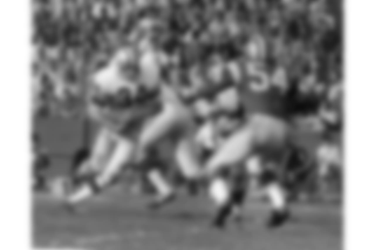 Rams running back Les Josephson (34) runs upfield as Cowboys linebacker Chuck Howley (54) closes in during the 1968 NFL Pro Bowl in Los Angeles, Calif. The West defeated the East 38-20. (AP Photo/NFL Photos)