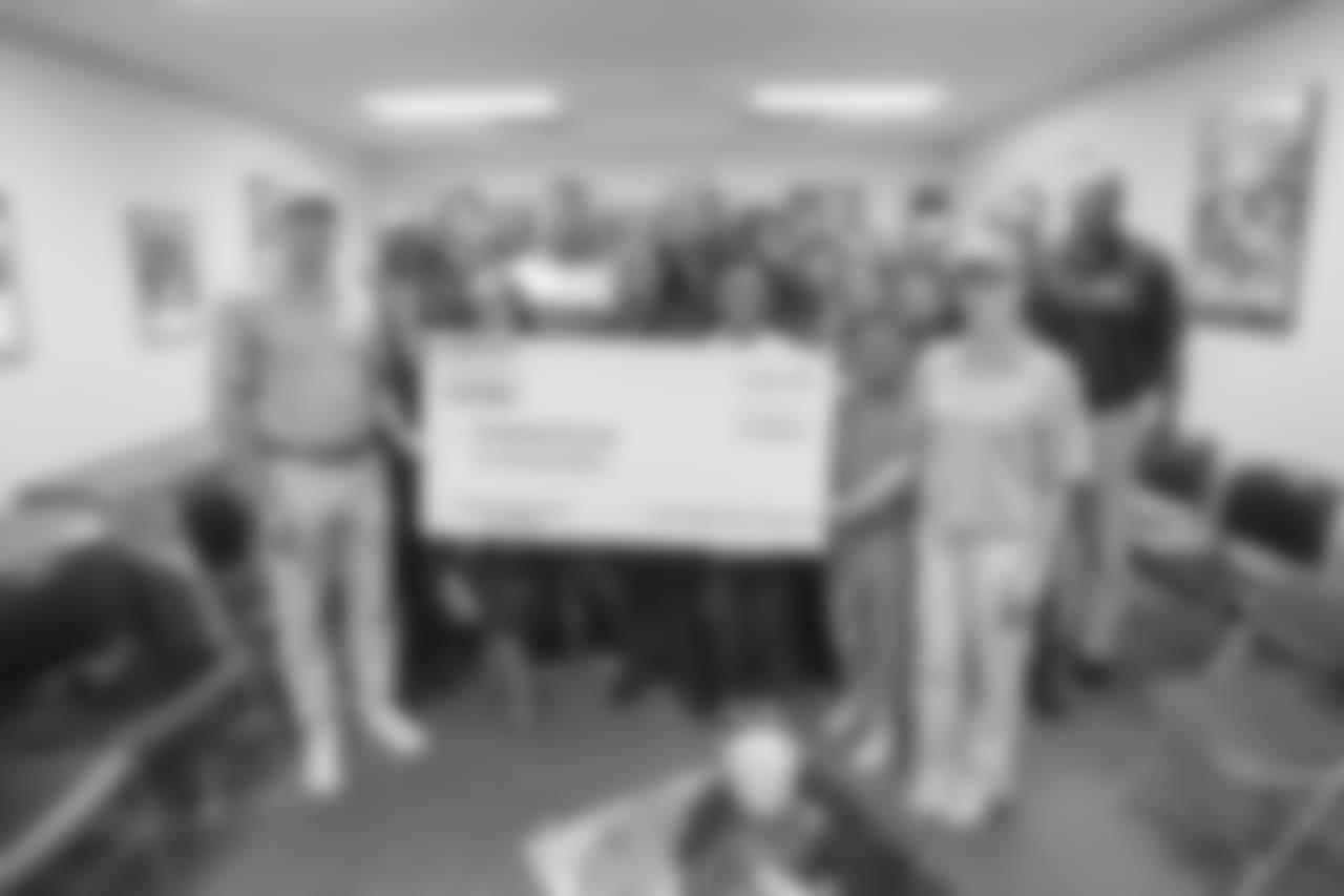 Defensive tackle (99) Aaron Donald of the Los Angeles Rams hands a check for $10,000 to the Brotherhood Crusade, Tuesday, October 22, 2018, in Los Angeles, CA. (Jeff Lewis)