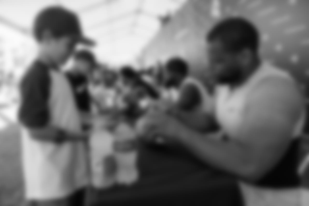 Defensive tackle (93) Ndamukong Suh of the Los Angeles Rams signs autographs during Day 5 of Training Camp, Monday, July 30, 2018, in Irvine, CA. (Will Navarro/Rams)