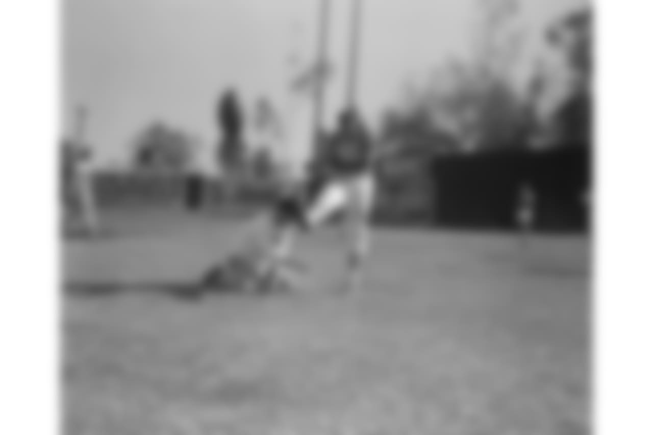 Les Richter doing some practice kicking during workout for Pro-Bowl game in Los Angeles, Jan. 8, 1958. Richter is shown holding the ball for 49ers ace passer Y. A. Tittle. (AP Photo/David Smith)