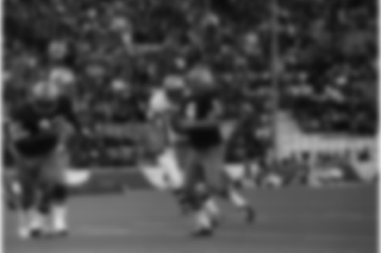 Washington Redskins quarterback Sonny Jorgensen (9) is about be overwhelmed by Dallas Cowboys George Andrie (66) and Jethro Pugh (75) as he scrambles in first quarter action, Dec. 6, 1970 in Dallas. Jorgensen was dropped for a 4-yard loss on the play, as he was unable to find a receiver open. (AP Photo/Ferd Kaufman)