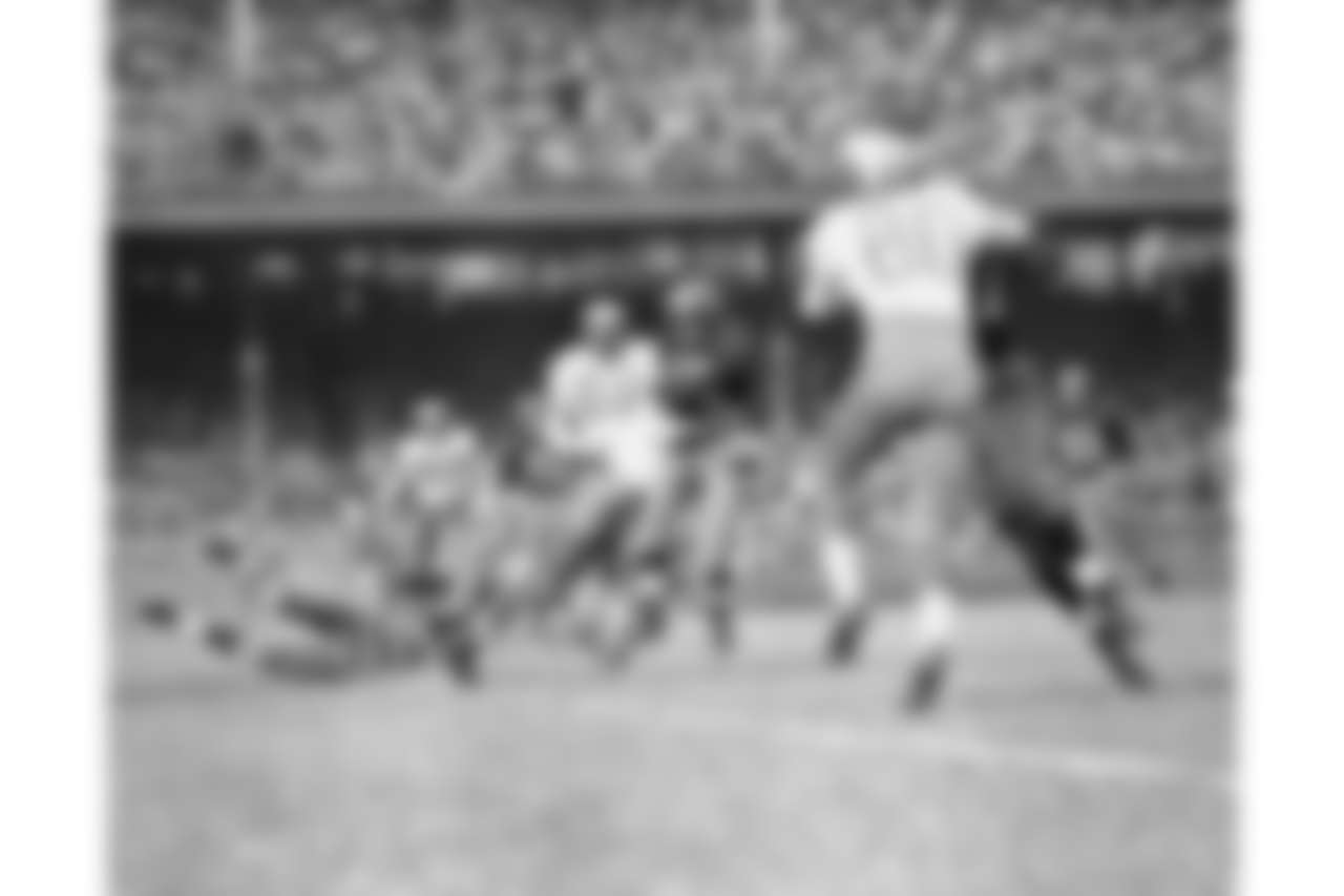 Bill Dudley, Washington Redskins ball-carrier is raised off his feet as Chuck Bednarik of the Philadelphia Eagles makes a solid tackle in the first quarter of a National Football League Game in Washington, on Nov. 12, 1950. Dudley lost a yard on the play. Other players: John Green (89), end, and Jay MacDowell (88), tackle, both Eagles, and Charlie Justice (22), back, of Redskins. (AP Photo/WCA)