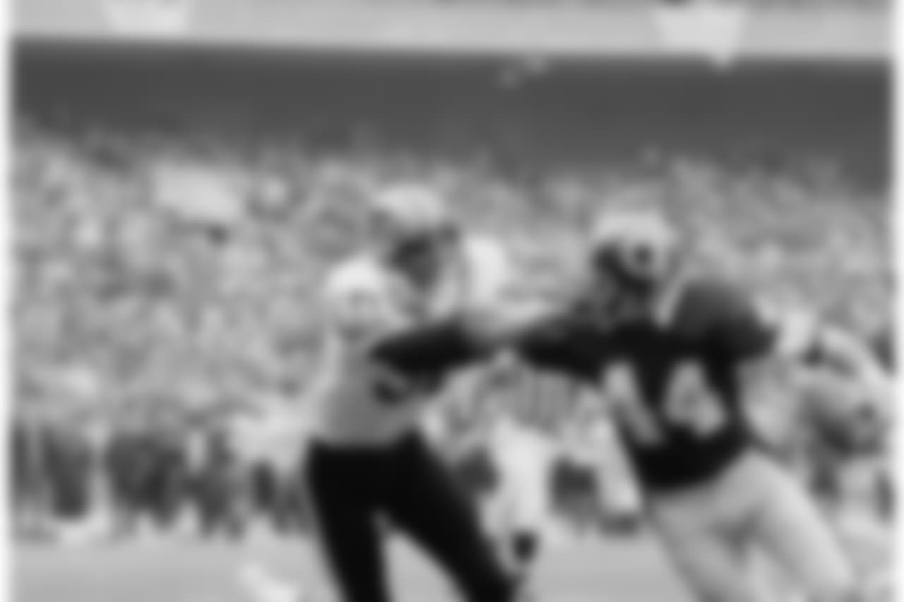 Washington redskins' full back John Riggins (44) is grabbed by the face mask by Ken Bordelon (50) of the New Orleans Saints during first quarter NFL football action in Washington, Oct. 28, 1979. (AP Photo/Barry Thumma)