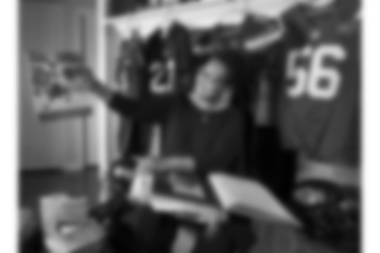 Sue Davis - Saints linebacker Demario Davis' mom - sifts through her "scrap bag" of news clippings, programs, and assorted memorabilia of her son's career at her home in Pearl, Mississippi, where Demario spent his teen years.
Photographed Thursday, December 13, 2018.
Behind her are Demario's jerseys from Brandon High School, Arkansas State, Cleveland Browns and the New York Jets.