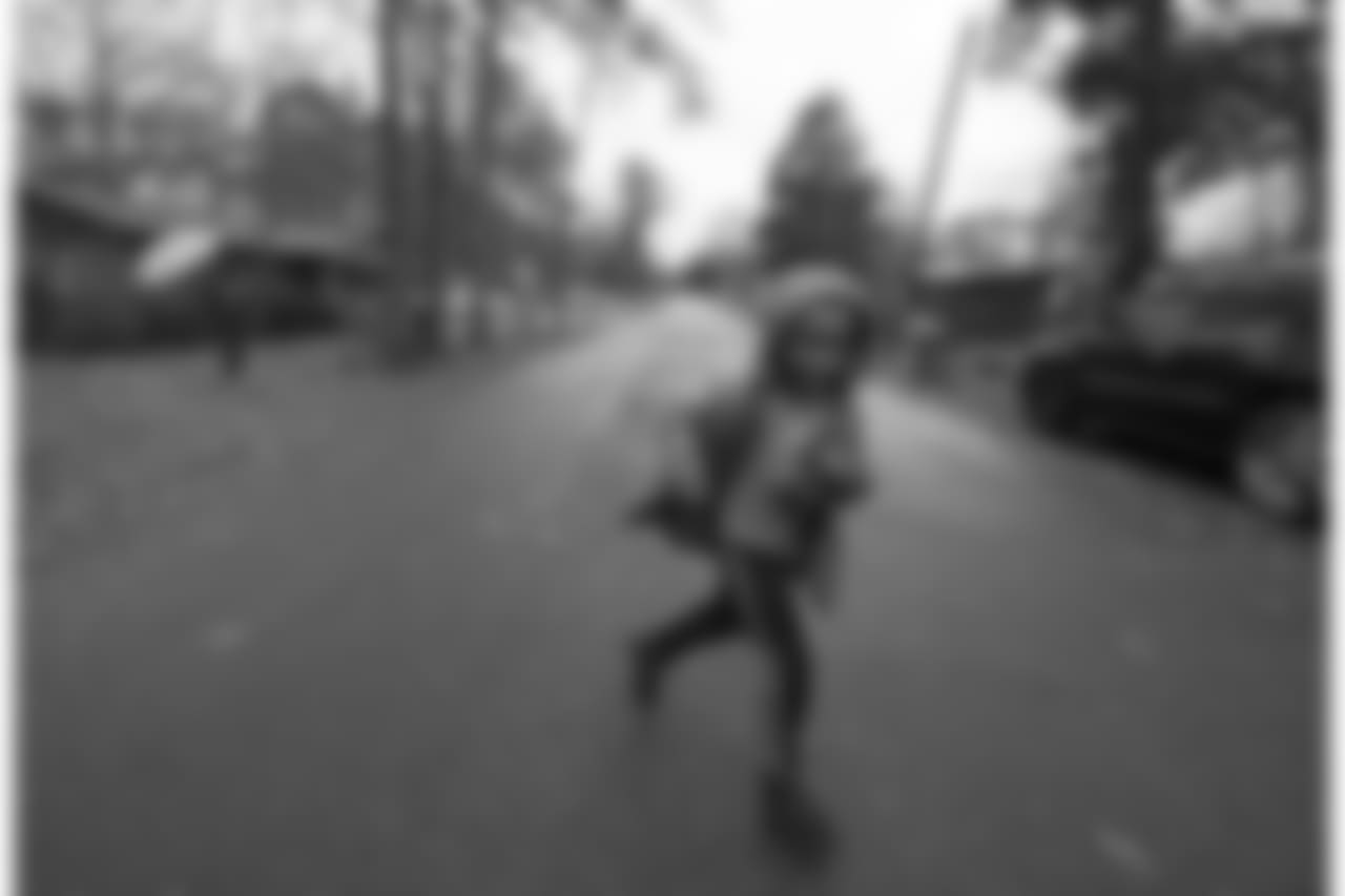 Elijah Keys plays in the street between two family homes in Collins, Mississippi as his cousin Maranda Magee follows with the umbrella.
They are both cousins to Saints linebacker Demario Davis, who spent his childhood years living here at his grandparent's home in Collins, Mississippi - shooting hoops in the side yard and learning the basics of football in the street with his cousins.
Photographed Thursday, December 13, 2018.