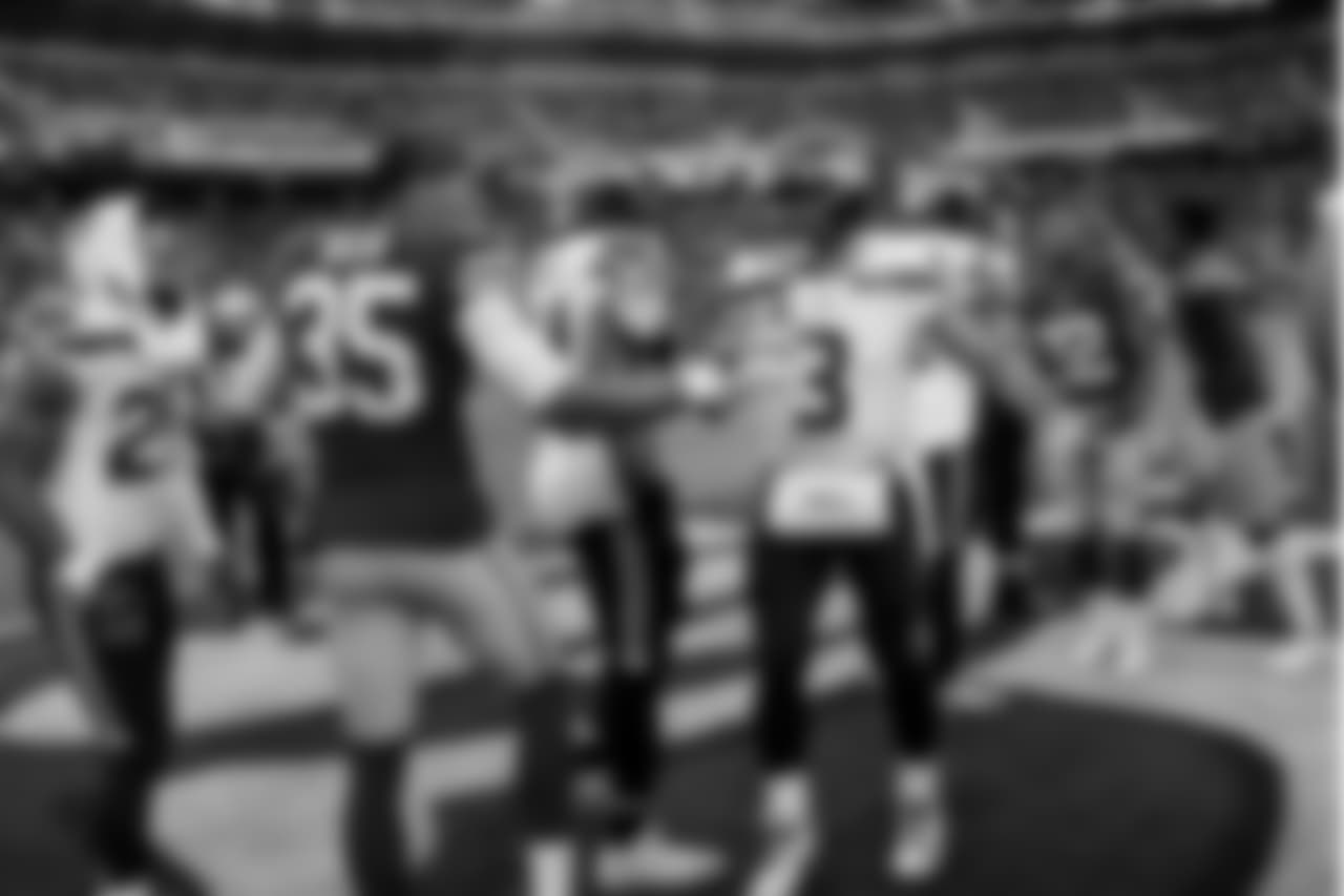 Seahawks quarterback Russell Wilson shakes hands with 49ers safety Eric Reid as the captains met at midfield for the pregame coin toss.