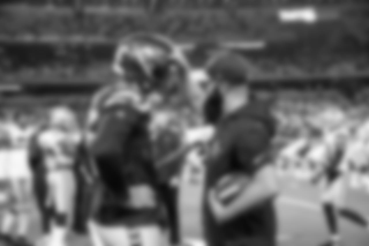 Seahawks defensive end Frank Clark visits with current Cowboys and former Seahawks assistant Kris Richard before the game.