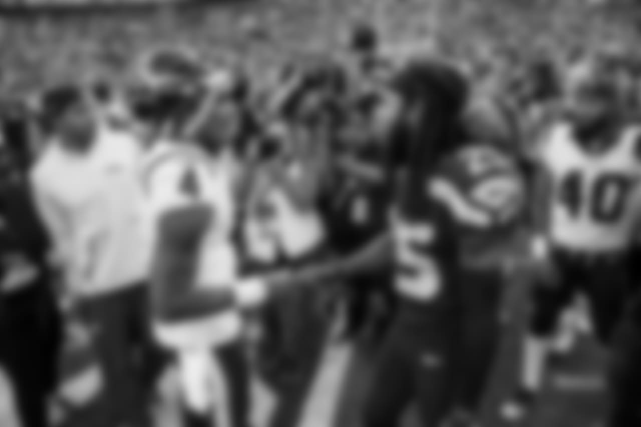 Houston quarterback Deshaun Watson and Richard Sherman meet at midfield after the game.
