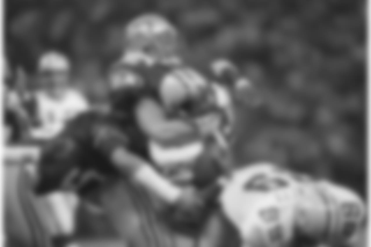 Brian Bosworth, top, of the Seattle Seahawks, tackles Kenneth Davis of the Green Bay Packers, holding him to a one-yard gain during the first quarter of their NFL game in Seattle, Nov. 15, 1987. Seattle beat Green Bay, 24-13. (AP Photo/Barry Sweet)