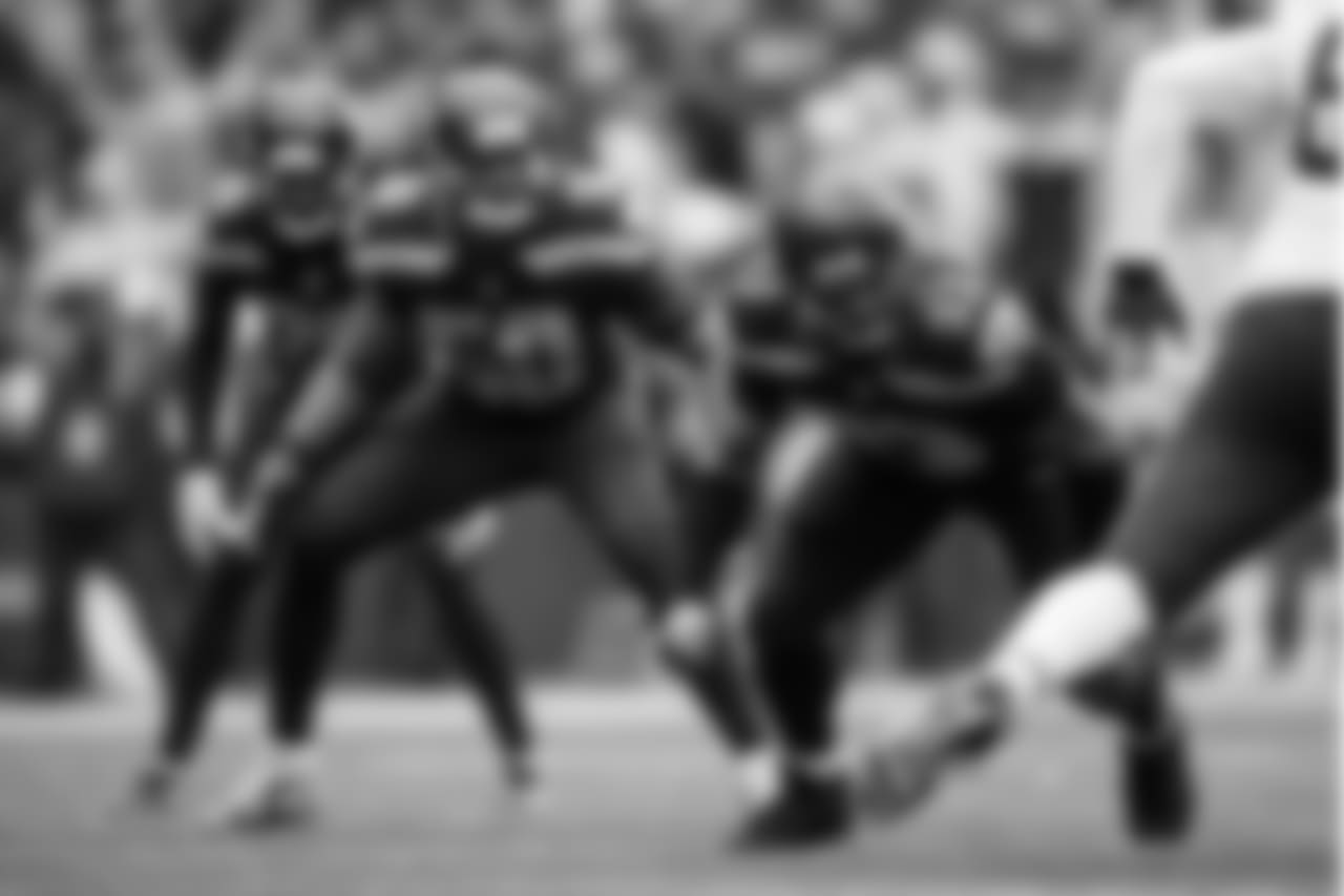 Seattle's Dwight Freeney rushes off the edge with teammates K.J. Wright and Shaquill Griffin lined up behind him.