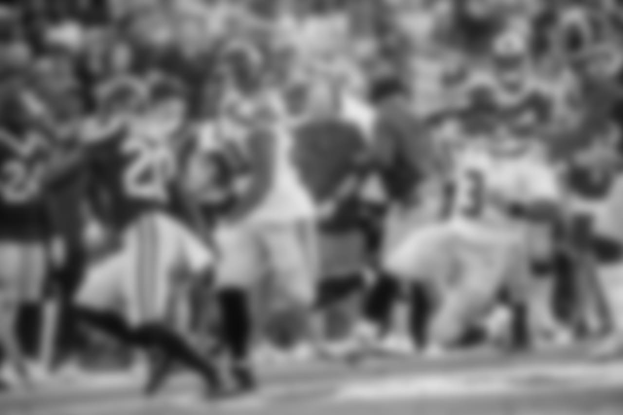 Seattle's Rashaad Penny runs up the right side as quarterback Russell Wilson attempts a block.