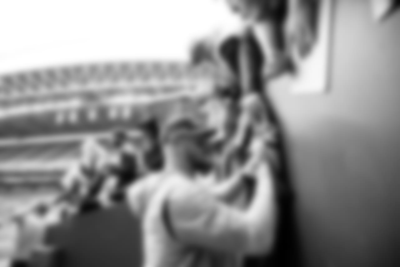 Nick Vannett signs autographs for fans near the Seahawks tunnel.