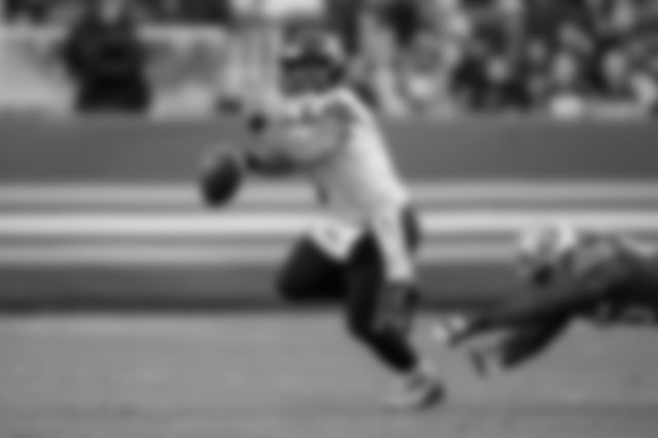 Seahawks quarterback Russell Wilson escapes pressure in the first quarter.