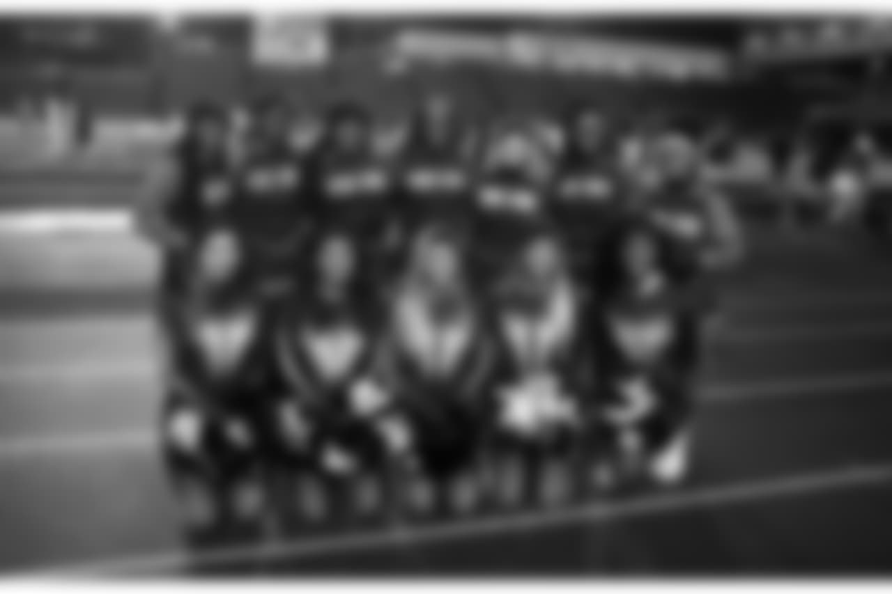 MEMBERS OF THE RAINIER BEACH CHEER SQUAD POSE FOR A PHOTO WITH THE SEA GALS BEFORE THE SEAHAWKS BLUE FRIDAY NIGHT LIGHTS GAME BETWEEN LINCOLN AND RAINIER BEACH DURING THE 3A STATE FOOTBALL PLAYOFF CONTEST AT LINCOLN BOWL. RAINIER BEACH WON THE GAME 14-7.